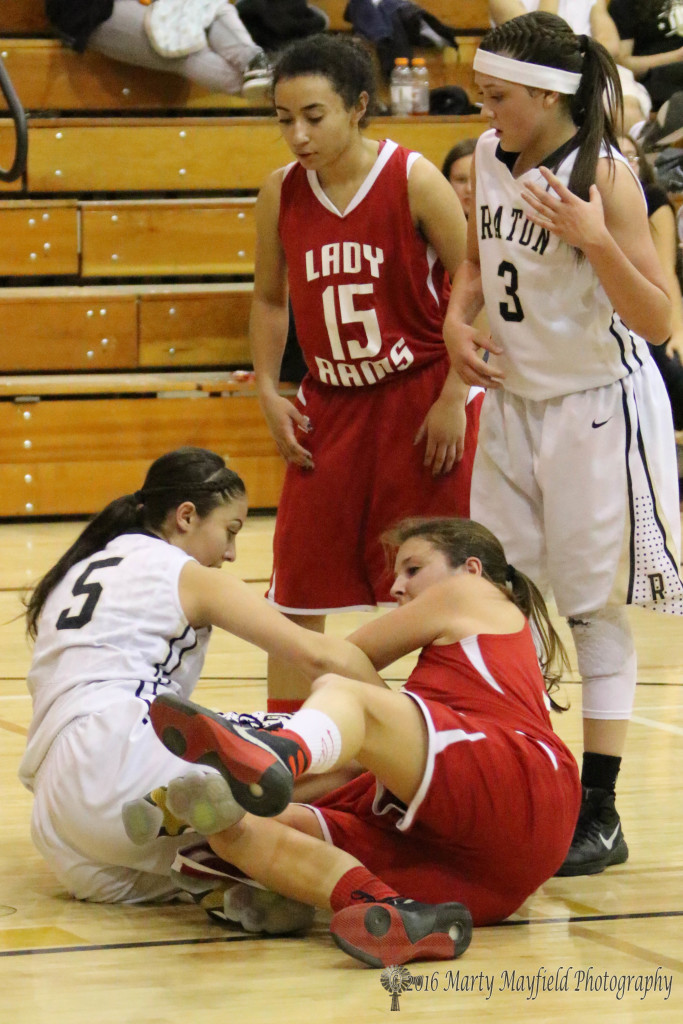 Sophia Madellini and Gentry Haukabo scramble for the possession of the ball late in the game Friday evening in Tiger Gym