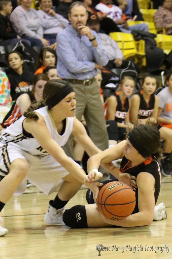 Alexis Romero reaches for the ball as J Sanchez goes to the floor during the JV game in tiger Gym Saturday afternoon