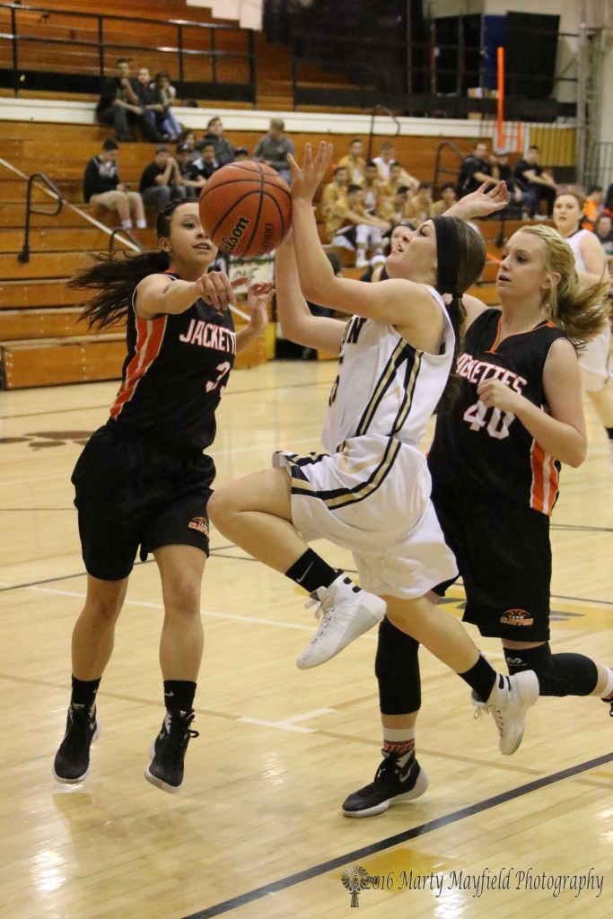 M Sandoval (3) got a hand on the ball as Alexis Romero goes in for the lay-up as Abby Lawerence is close behind.
