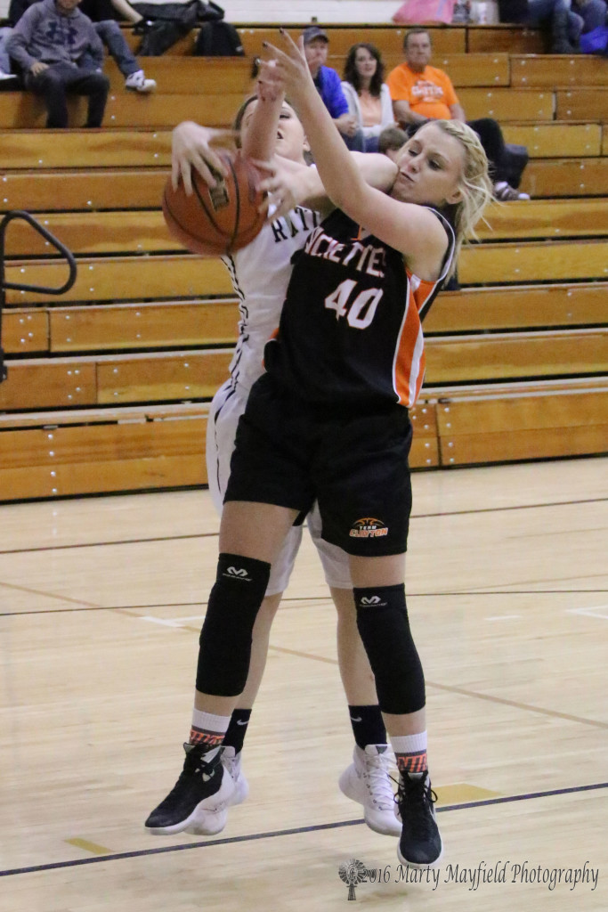 Kerrigan Weese and Abby Lawrence tangle on the rebound during the JV game in Tiger Gym