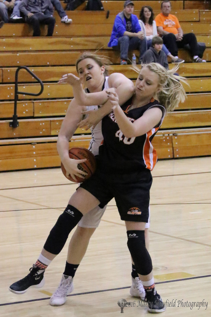 Kerrigan Weese and Abby Lawrence tangle on the rebound during the JV game in Tiger Gym