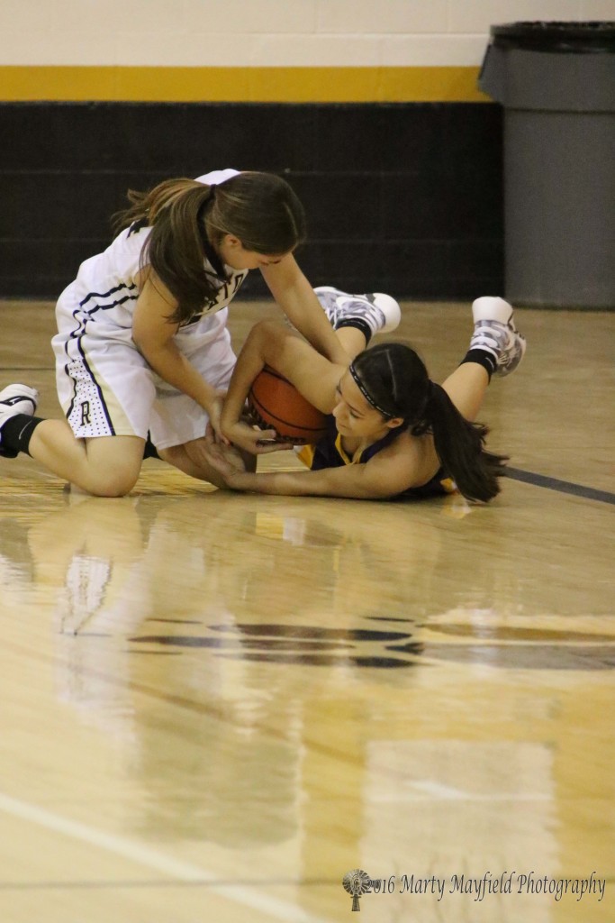 Andie Ortega and Aliyah Herrera struggle for the ball during the girl's JV game Saturday.