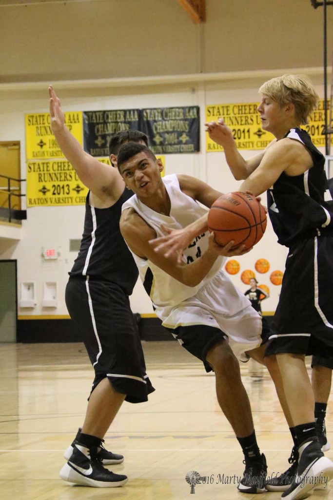 Darien Lewis drives down the lane through traffic during the JV game in Tiger Gym