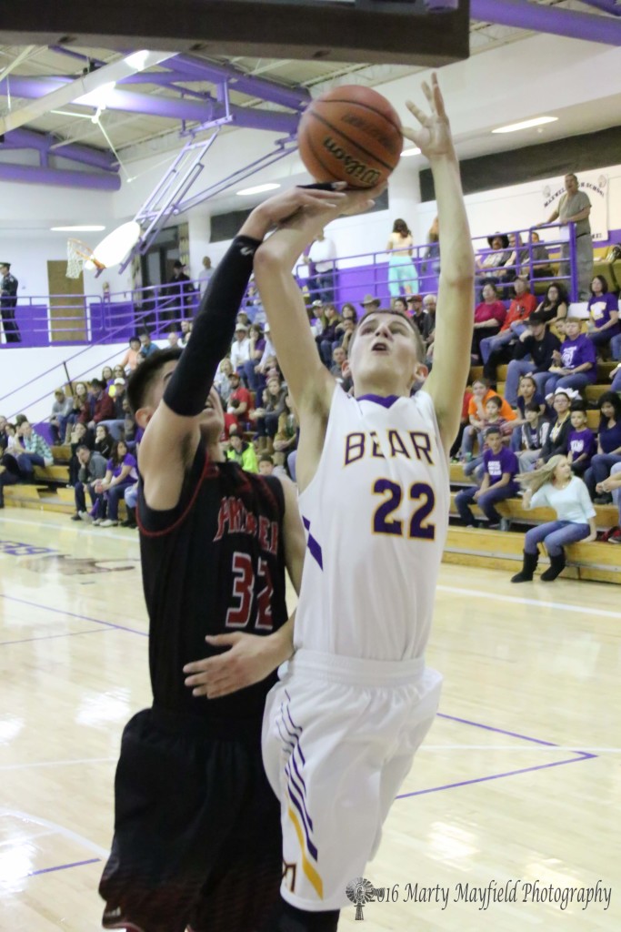 Kolten Riggs (22) goes up for the shot as Zac Caldwell (32) gets a hand in the way during the homecoming game in Maxwell
