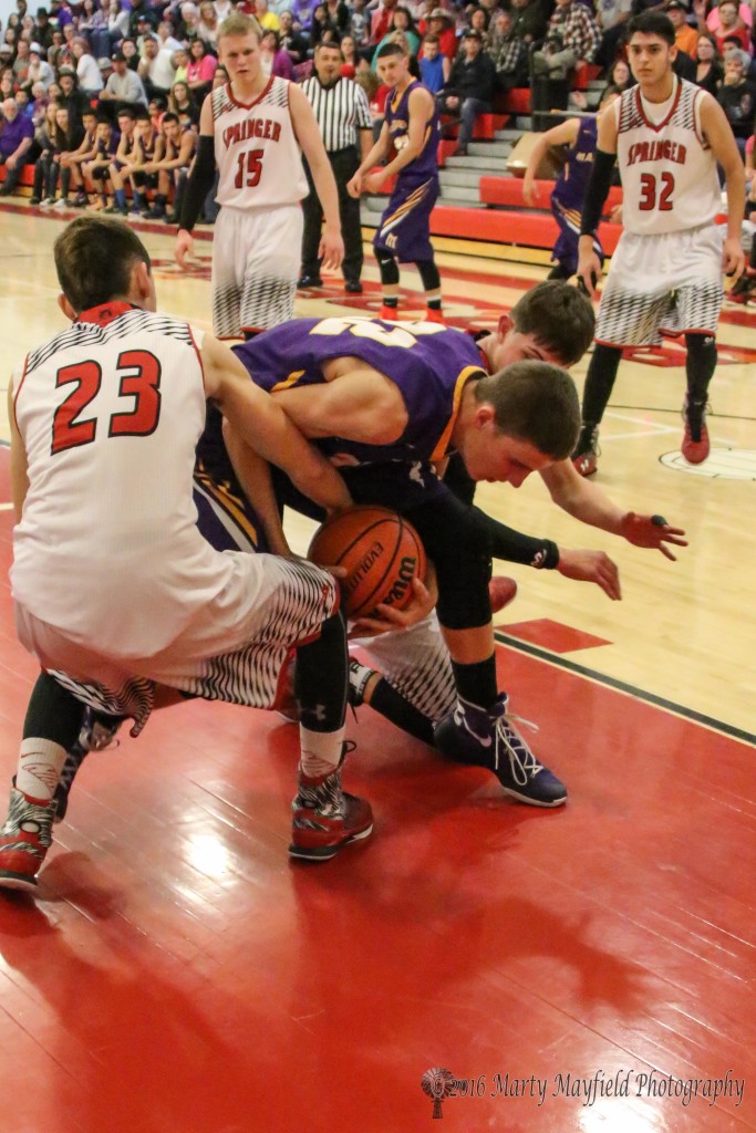 Its a scramble for the loose ball as Kolton Rigs (22) battles with Estevan Romero and (23) and Isaiah Garcia for control. The ball eventually went out of bounds and was turned over too Springer as Riggs touched the ball on the line.
