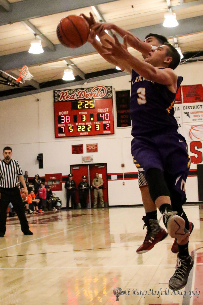 Jeremy Archuleta (3) and Zac Caldwell battle for the rebound during the district championship in Springer