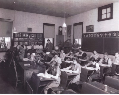 Classroom in the Sugarite School: Principal Loren Malcolm is shown in the back of the classroom, next to the chalkboard. (Courtesy of Joe Bertola Family)