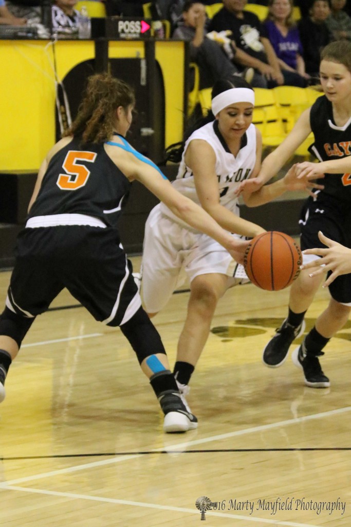 Kathleen Sandoval (5) gets a hand on the ball and forces the turnover as Natasha Ortega (2) tries to work her way through traffic headed for the basket during the varsity game in Tiger Gym Saturday evening.