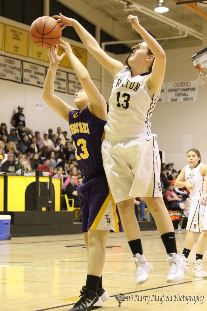 Halle Medina (13) gets a hand on the ball as Destinee Montano (13) works for the rebound. 