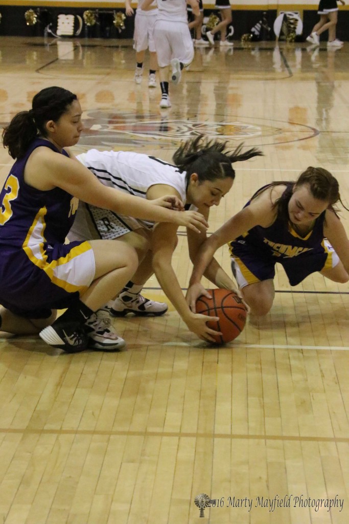 Sophia Maddaleni and Alyssa Martinez struggle for the ball as Destinee Montano reaches in to help out. 