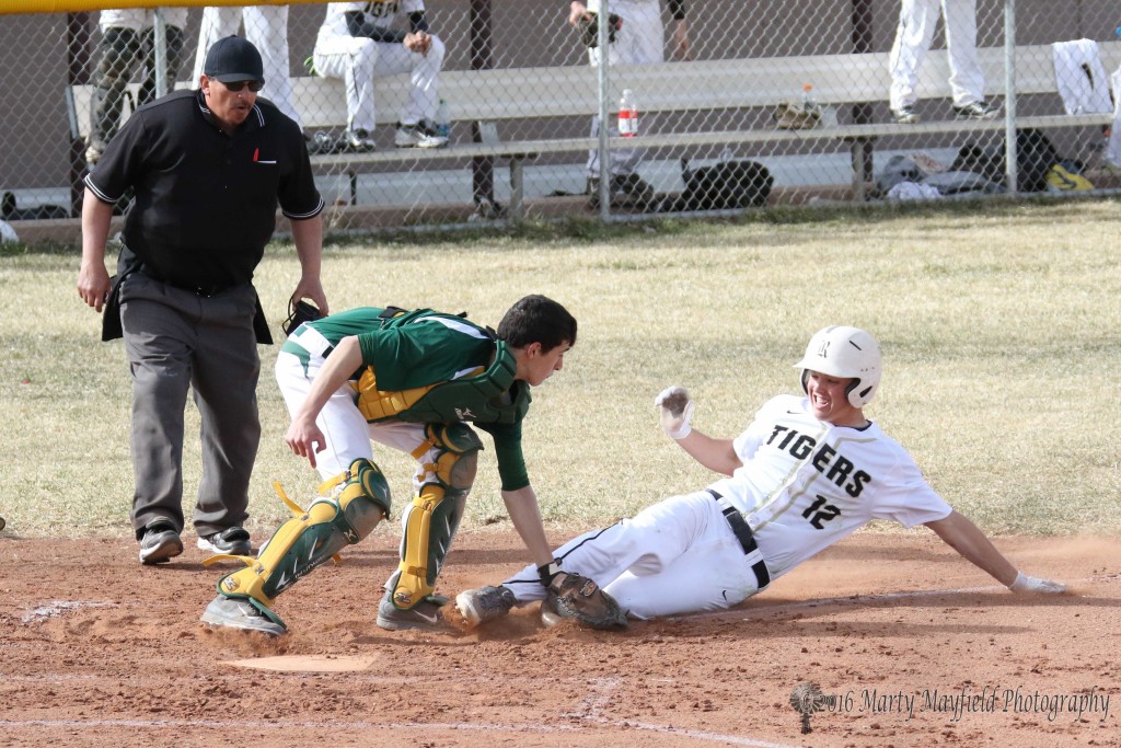 Dillon Lemons slides for home but catcher Jeffery Sanchez makes the tag well before Lemons touches the base. 