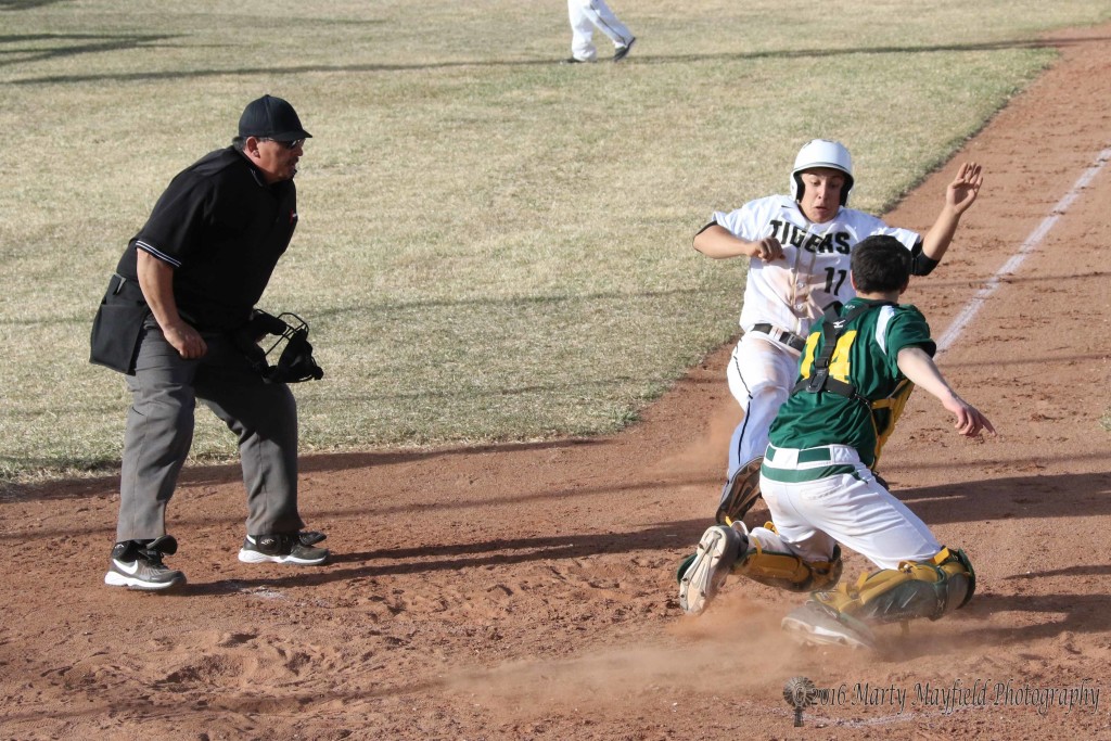 Brandon Luksich slides for home plate as Jeffery Sanchez makes the catch and the tag for West Las Vegas. 