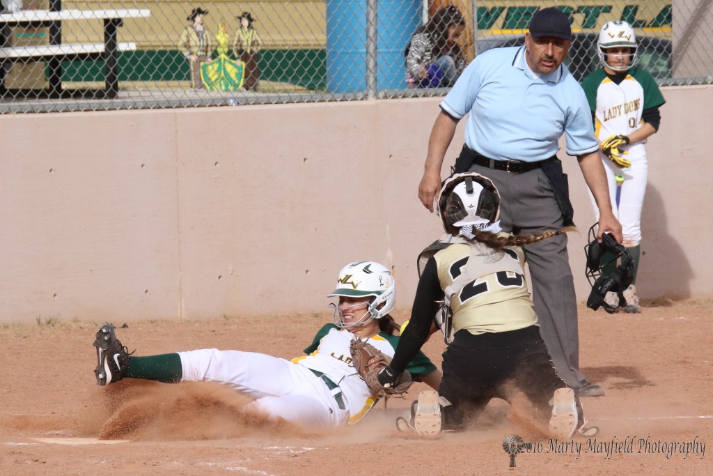 Safe at home is the call as Camryn Stroeker had the ball in her hand and touched the runner with her glove as she slides into home.