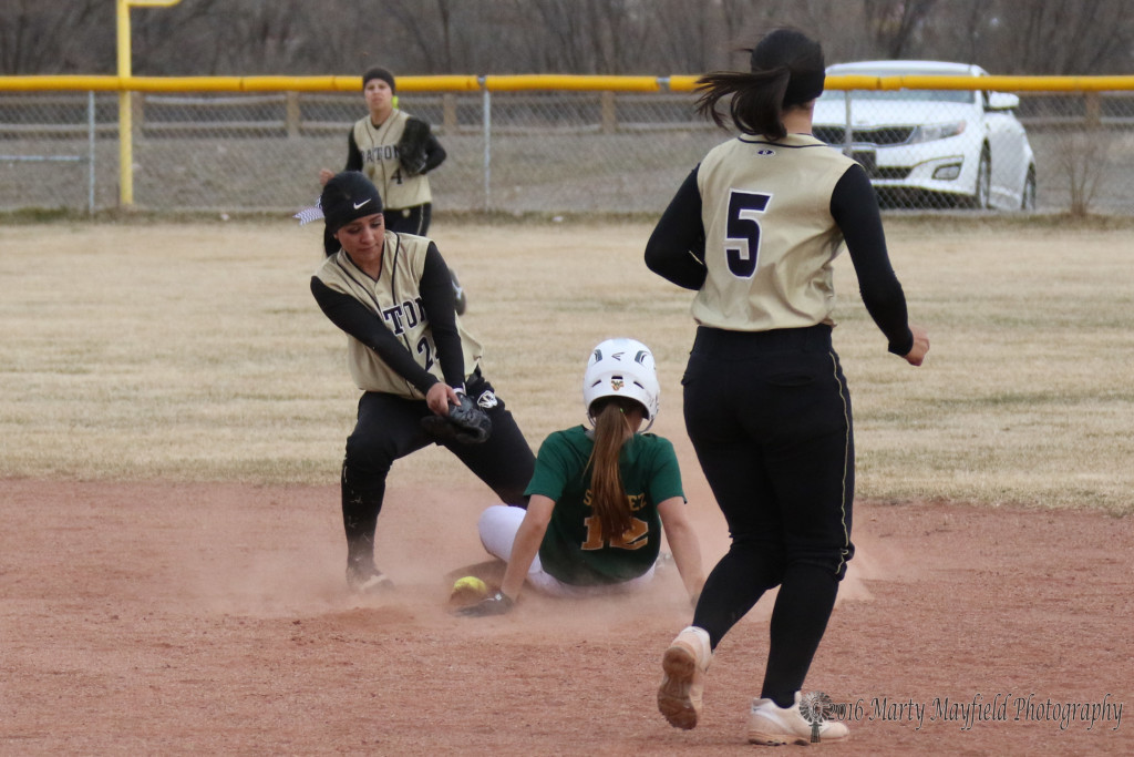 oops as the ball finds its way to the ground and a steele by jasmine Sanchez comes up safe.