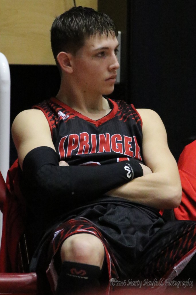 A disappointed Isaiah Garcia sits watching his team after fouling out early in the third quarter of the championship game.