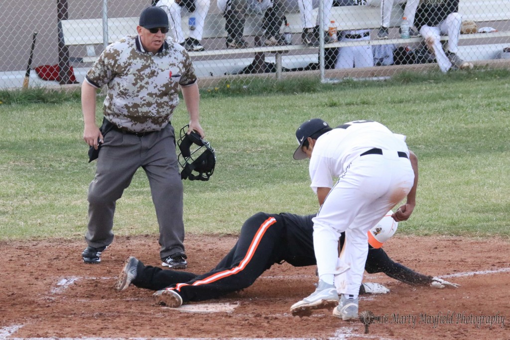Jonathan Cabrieles reaches down for the tag as #11 slides safe into home plate.