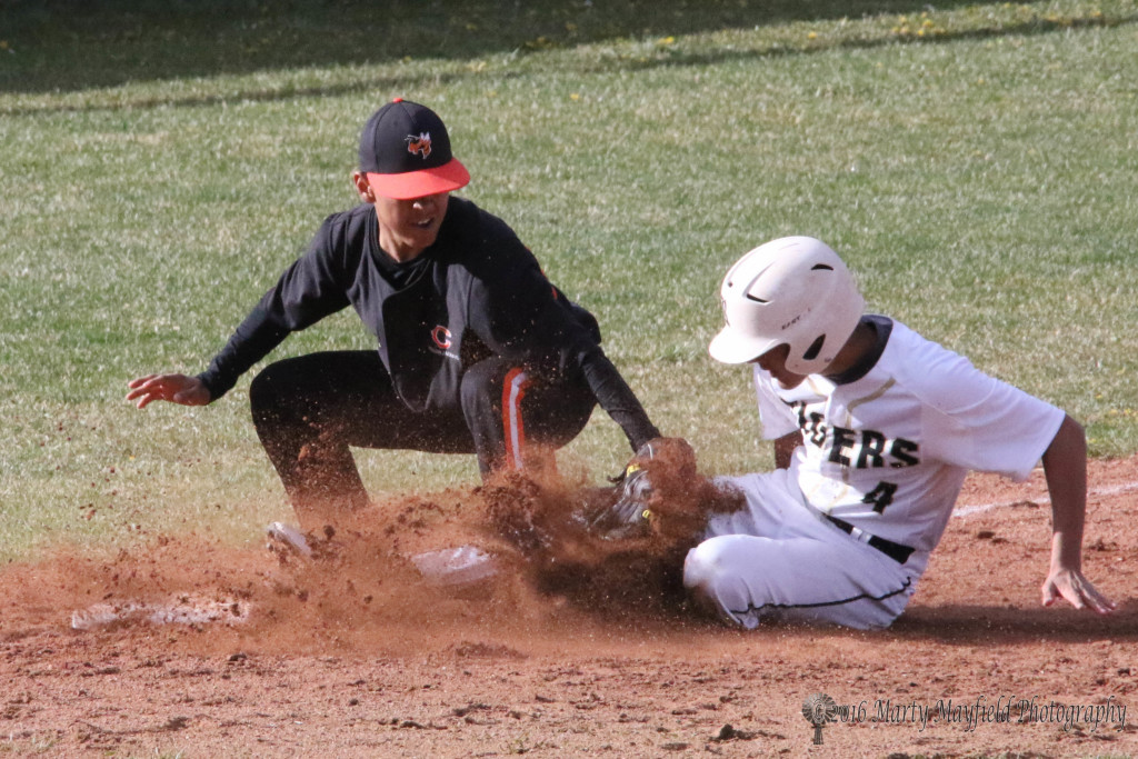 Ethan Slides is called out as he slides into third base late in the Clayton double header