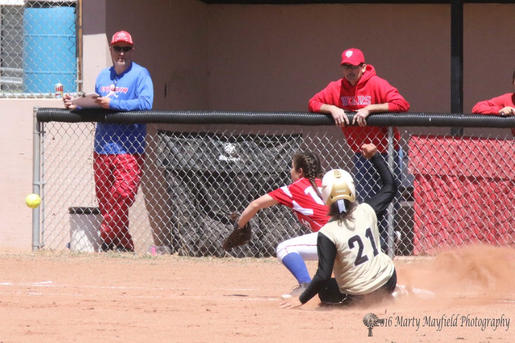 Natasha Archuleta slides for third as the throw from the catcher comes flying in. 