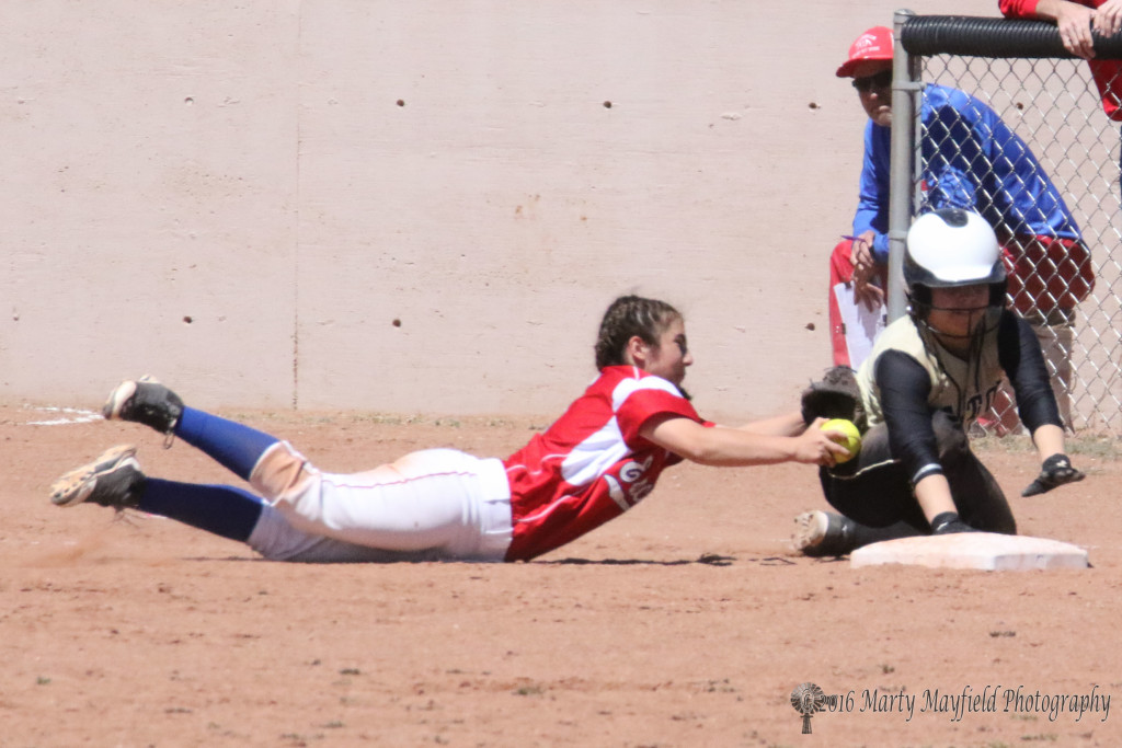 Third baseman Laney Chavez reaches for the tag as Montana Trujillo touches the bag just in time Saturday afternoon 
