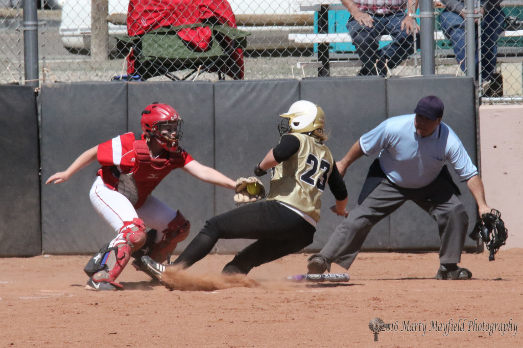 Lynsey Plant reaches for the tag and the out as Jadyn Walton slides home 