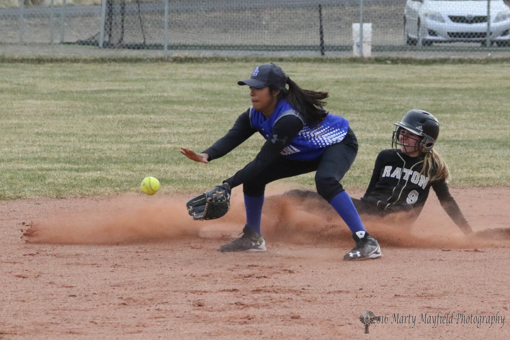 Mariah Encinias slides into second as the ball arrives from left field after her big hit. 