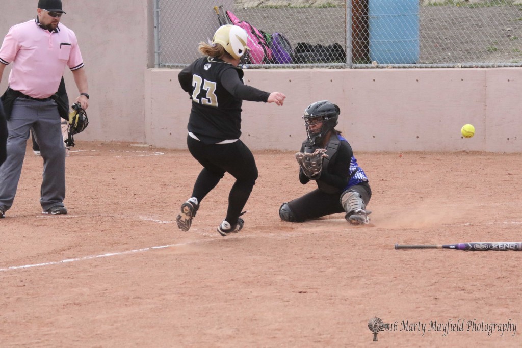 Jadyn Walton makes it safe at home as the ball flies by the catcher Friday afternoon in a double header with Laguna Acoma