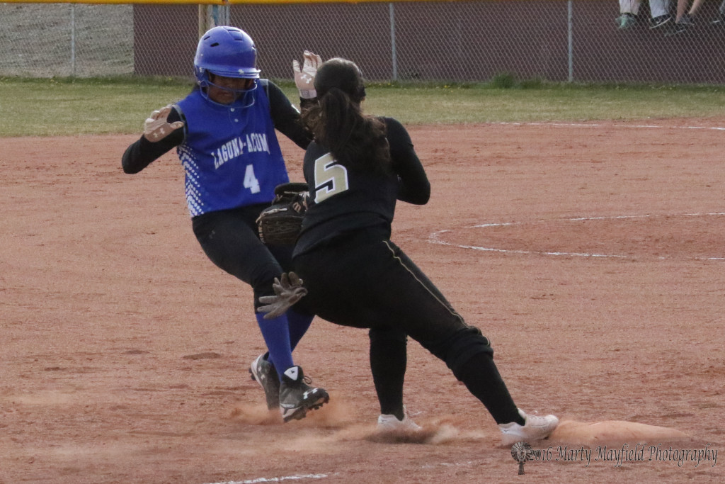 Shortstop Sophia Madellini makes the play at third and the out as Jaelynn Riley runs for the base.