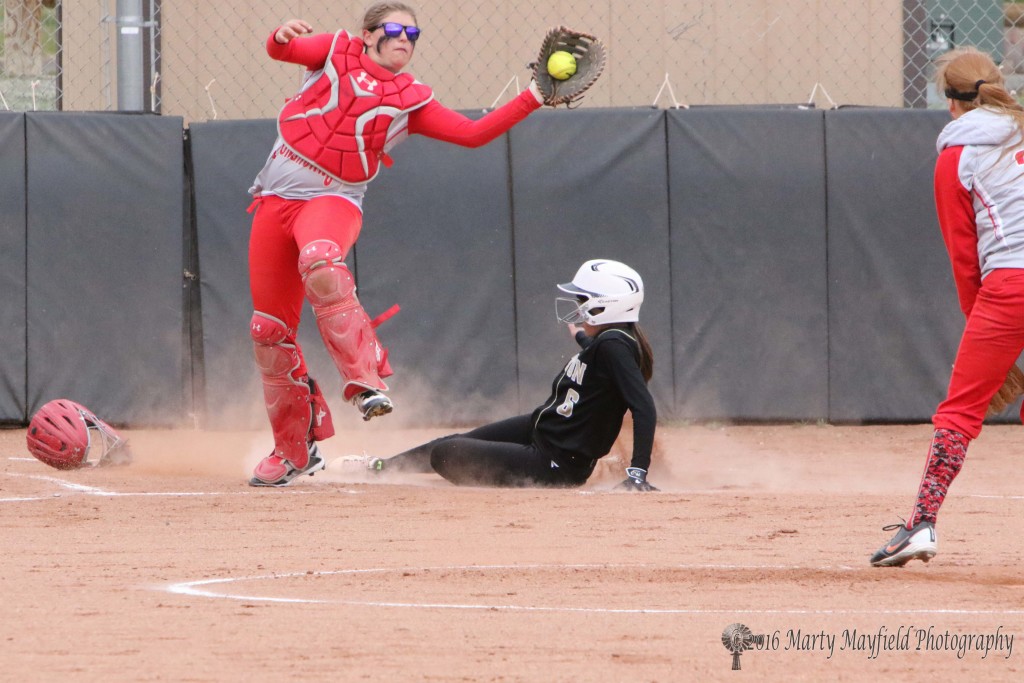 Estrella Vargas slides home to add another run to the Lady Tigers early in the game one of the double header with Logan.
