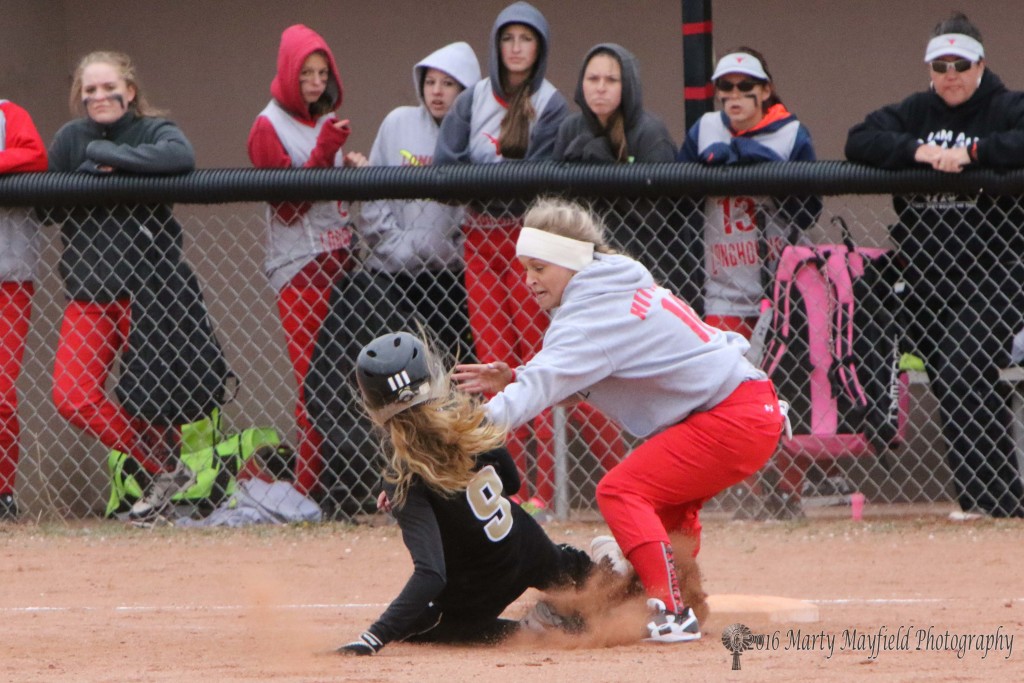 Mariah Encinias continues her trip around the bases as she slides in below the tag by Kaitlind Hittson