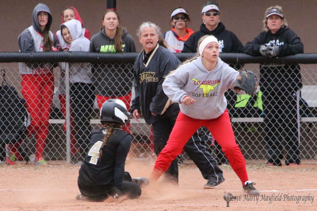 Montana Trujillo slides safe at third well before the ball reaches Katelind Hittson's glove