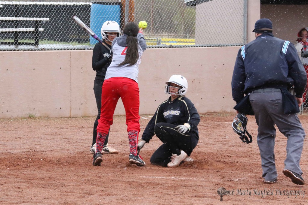 Sophia Maddelini makes it home before the ball gets to pitcher Cassie Lovato for the tag.