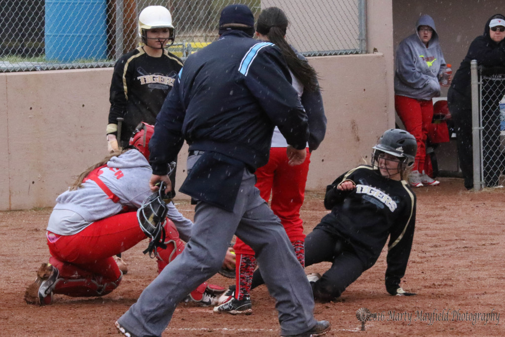 Once again Mariah Encinias slides in below the tag as she makes it home for another Raton run. 