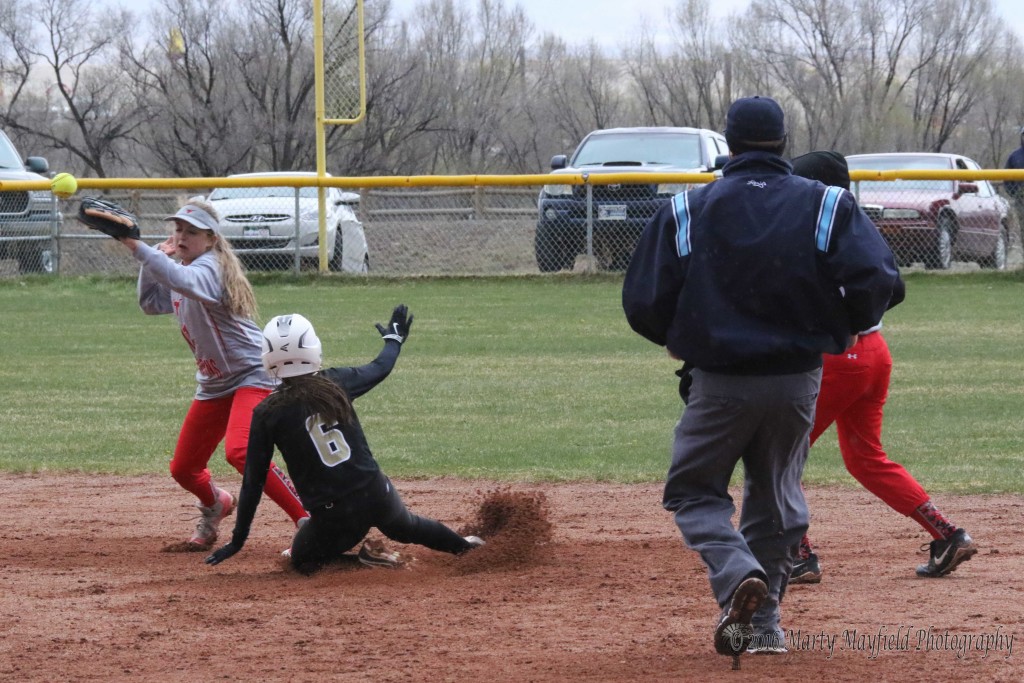 Estrella Vargas slides into second as Paige Moralez can't handle the throw from the catcher.