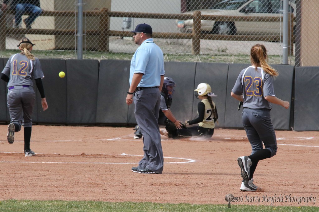 Safe at home as is Lady Tiger Camryn Stoecker as catcher Loren Chavez can't hang on to the ball 