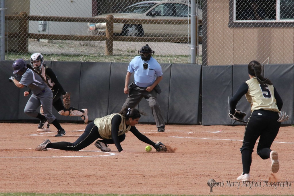 Raton Pitcher Natasha Archuleta stops the ball and makes the play at first.