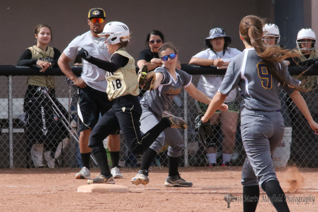 Halle Medina was called out on her way to first as first baseman Emma Garcia reaches for the tag. 