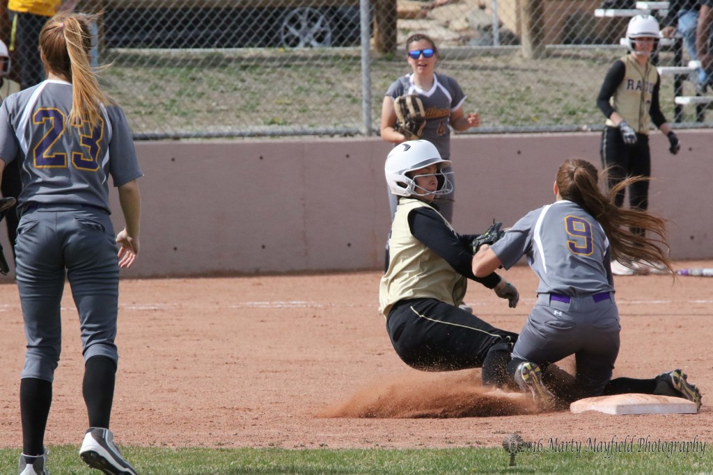 Sophia Madellini was called safe as she slides into second as Lazara Garcia goes for the tag.
