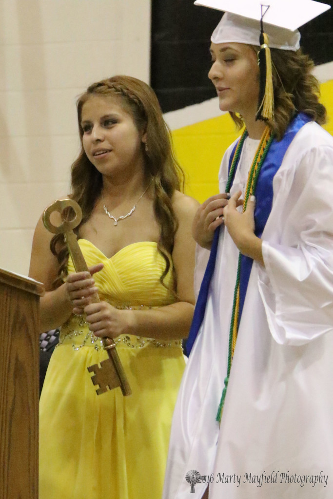 Senior Class President Alee Bird presented the school Key to Junior Class President and cousin Montana Trujillo at Friday evening's commencement ceremony