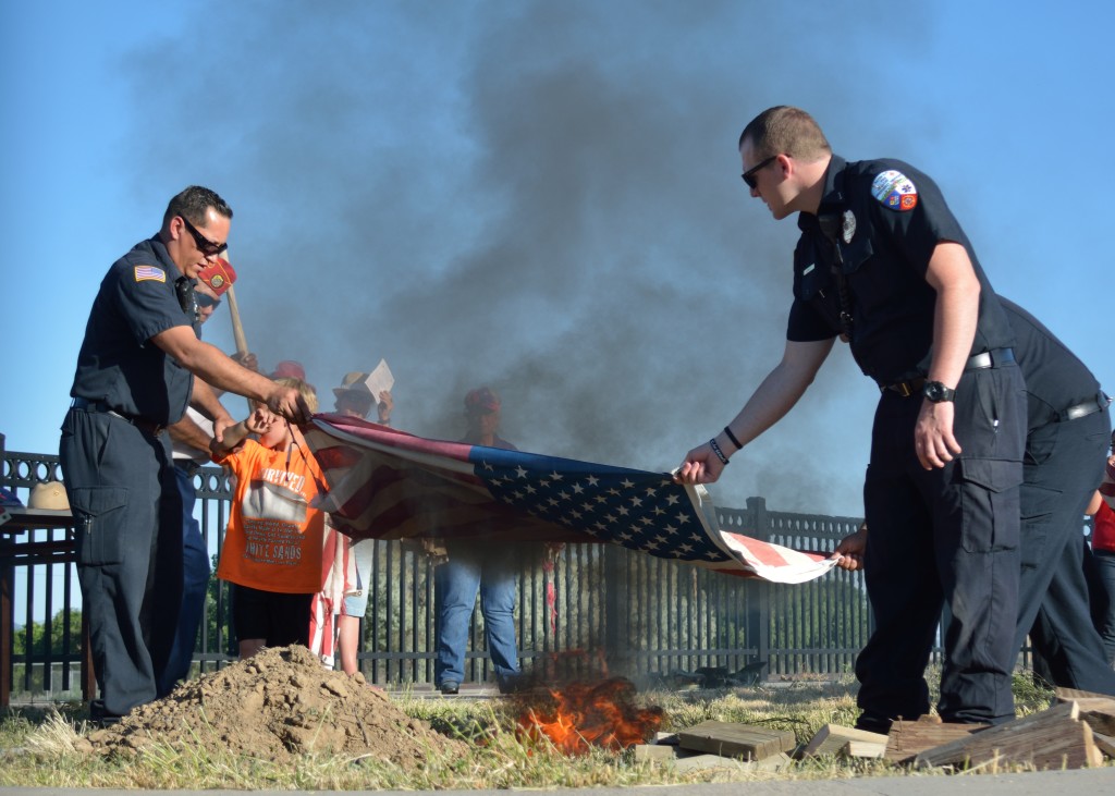 RFES Firemen David Valdez and Jacob Butt prepare to retire this flag during the flag retirement ceremony Tuesday evening.