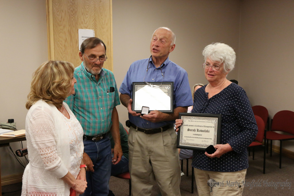 Mike and Sara Kowalski were presented the You Rock pin and certificate for their volunteerism around town from Commissioners Lindé Schuster and Don Giacomo.