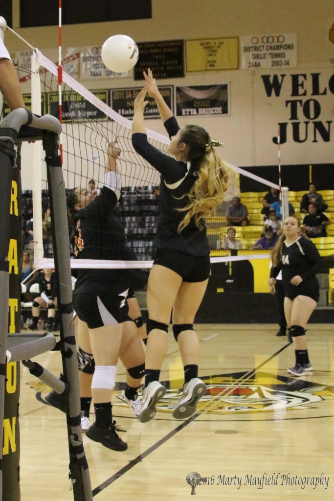 Camryn Stoecker gets the block as Aspin Borja catches a finger in the net to get called on a net violation during the RHS Tourney thursday evening in Tiger Gym