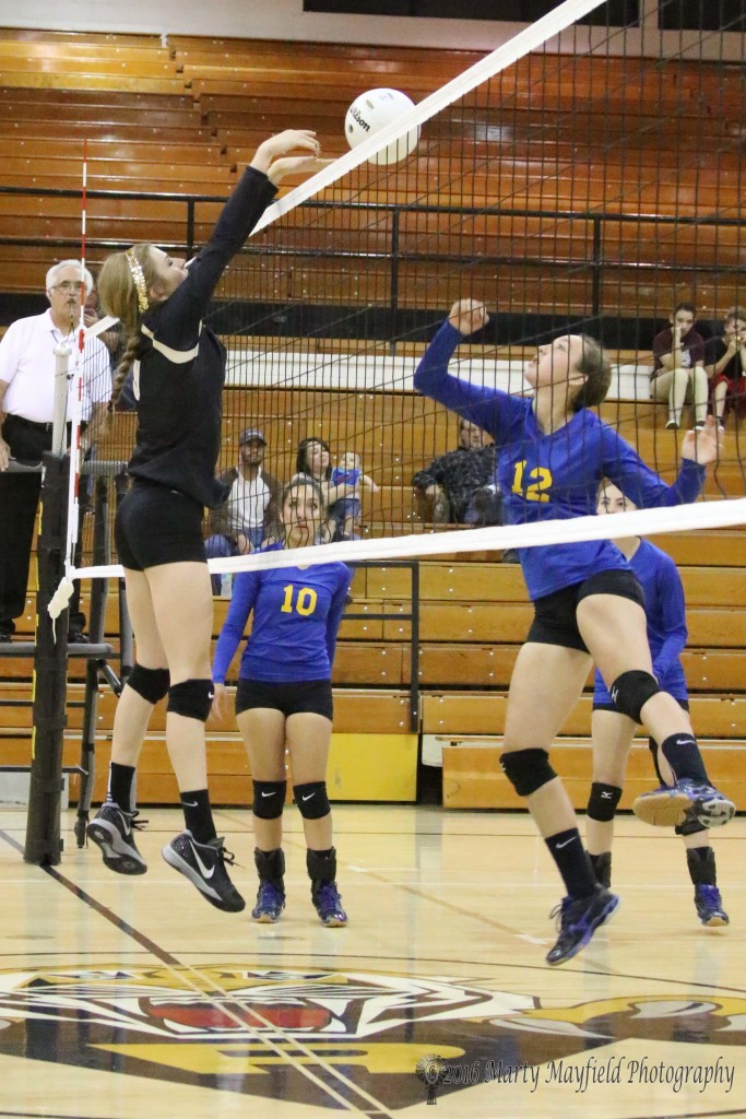 Alina Pilmore gets the block on Ariana MacAuley stab over the net Thursday evening during the match with Peñasco