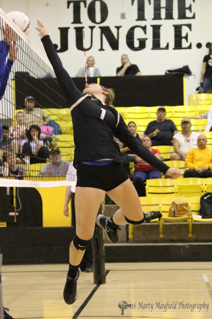 Camryn Mileta pushes the ball over the net during the match with Peñasco Thursday evening in Tiger Gym