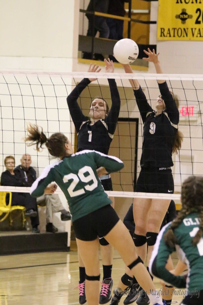 Camryn Mileta (1) and Alina Pilmore (9) go for the block as Rebecca Soifer (29) makes the hit over the net during the District Championship Friday evening in Tiger Gym.
