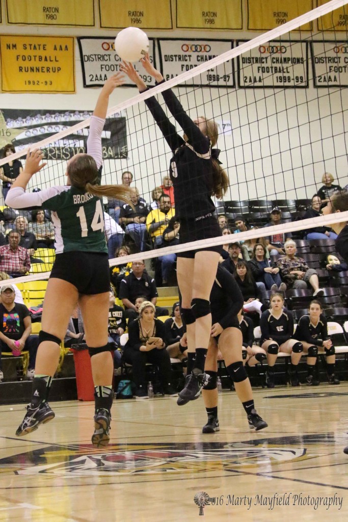 Alina Pilmore gets a finger on the ball after Courtney Brookover tips it up and over the net.