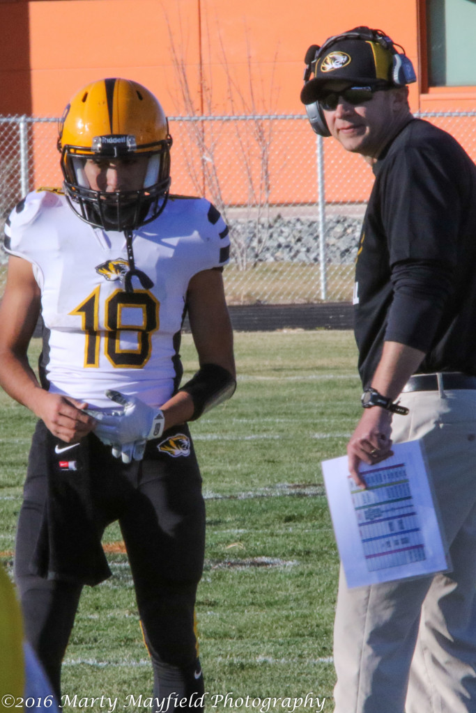 Trying to figure out what play to send in next Coach Tory Giacomo and quarterback Dustin Segura talk it over. 