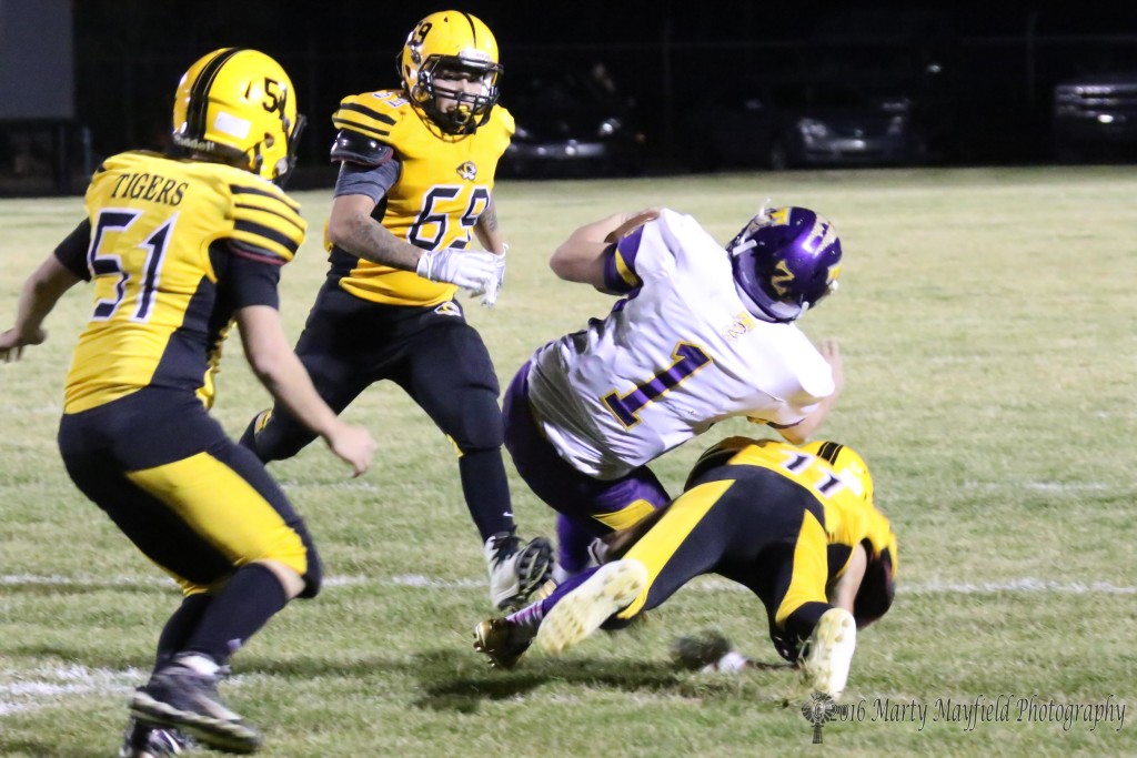 Ismael Tafoya gets the tackle as Zach Martinez attempts a spin move to try and prevent the a loss of yardage on the play.