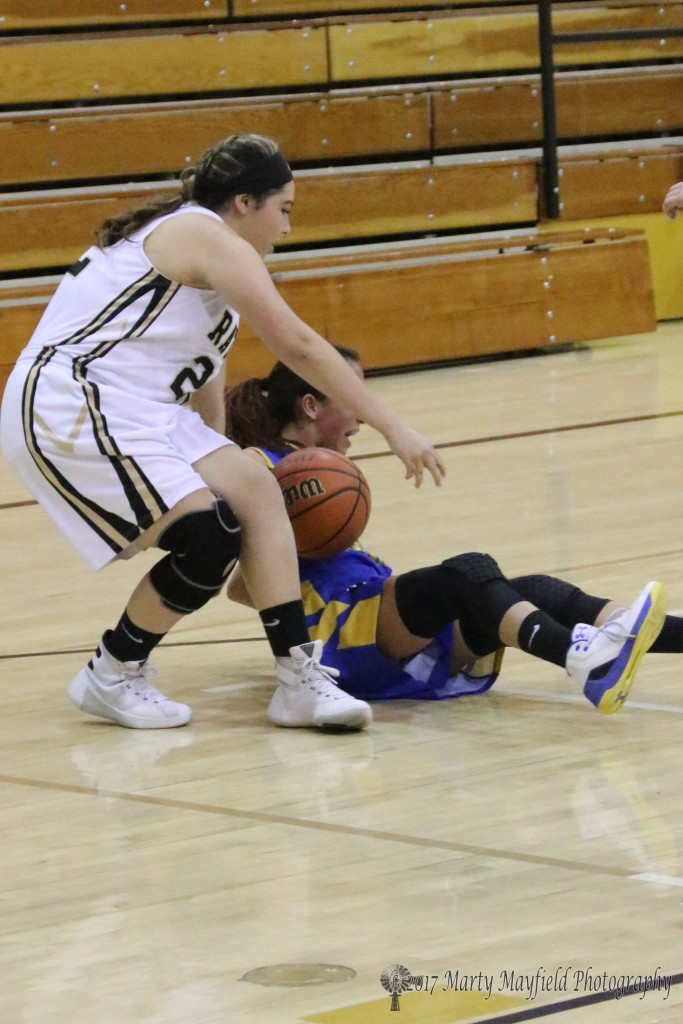 Marklyn Pacheco and Ashley Zamora tangle for the ball late in the girls JV game Saturday afternoon.