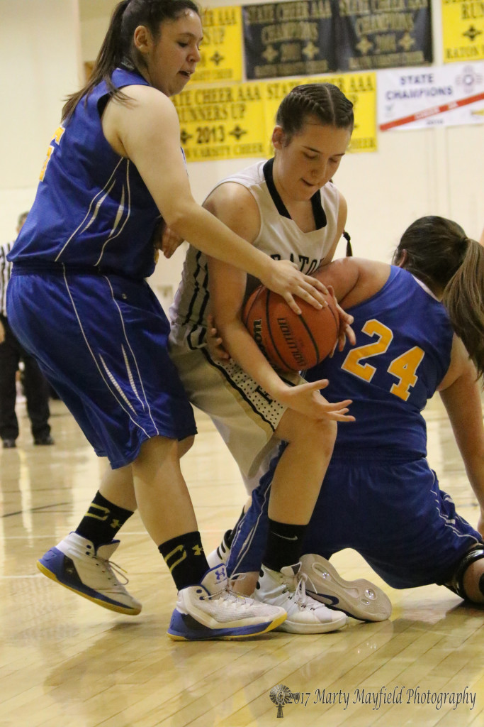 Halle Medina tangles with Megan Romero (24) and Jordyn Vargas (55) for the ball in the varsity game Saturday evening
