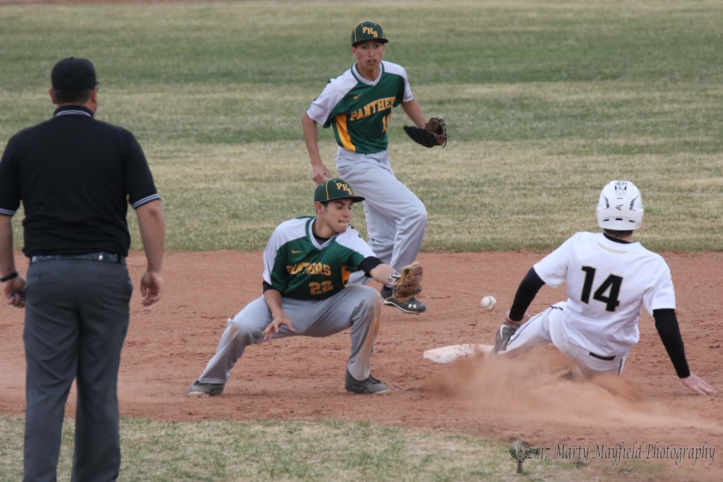 Robert Horner makes the slide into second for the stolen base as the ball gets away from Cameron Quintana during the district game with Pecos Tuesday afternoon